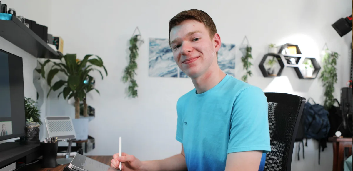 High school student taking notes during an online class at home