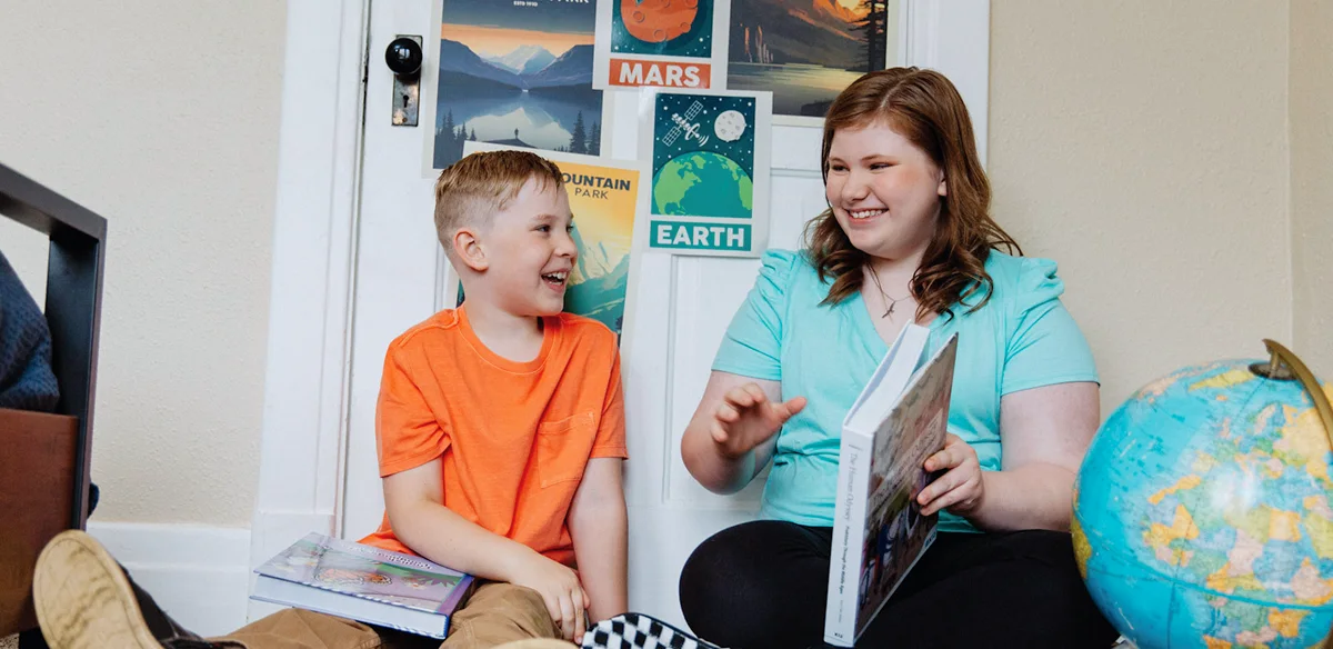 girl and boy smiling and learning together