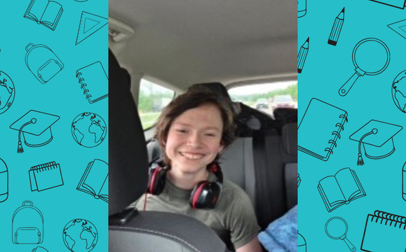 Cody in the backseat of car smiling