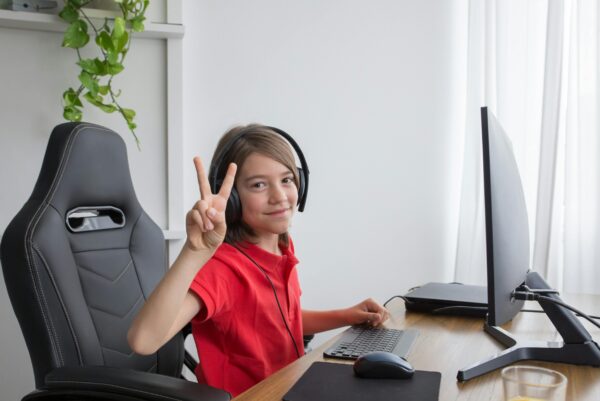 boy smiling and using the computer